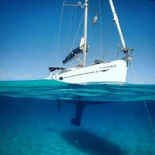 A sailboat hull with its keel visible below the waterline