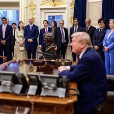 Executive leaders seated together at a business meeting