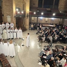 A choir singing in a church during a Gregorian chant performance.