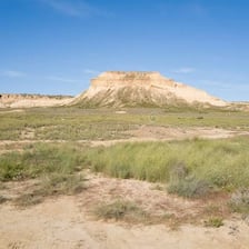 A broad, flat-topped mesa rising above a desert landscape.