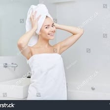 A person modestly wrapped in a towel, illustrating the idea of being without clothing.