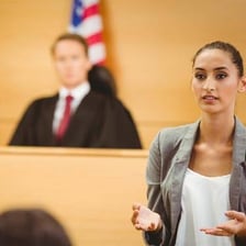 A person making a formal statement in a courtroom.