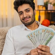 A person counting a small amount of money carefully.