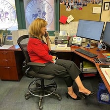 An assistant helping a colleague in an office
