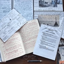 An open novel manuscript with notes outlining its storyline.