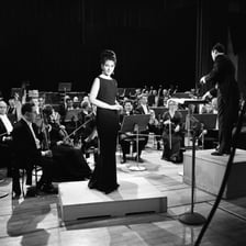 Maria Callas performing on an opera stage.