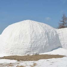A dome-shaped igloo made of snow blocks