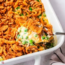 Green peas visible in a baked casserole