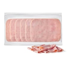 Sliced ham displayed at a deli counter
