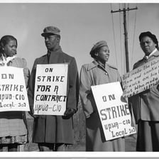 Workers standing together on a picket line