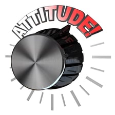 A hand turning up the control on an audio amplifier.