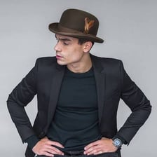 A derby hat displayed beside a fedora.
