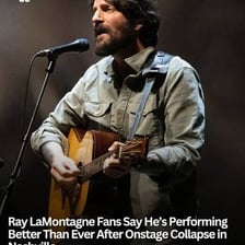 A musician returning to the stage while an audience applauds