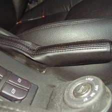 A car parking brake shown in the engaged position.
