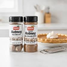Whole and ground nutmeg used as a spice.