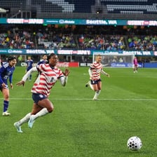 Players competing in a soccer match on a grass field