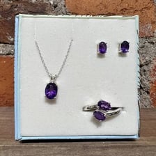 Colored gemstones set into rings and other jewelry.