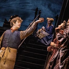 A group of actors performing together on a stage