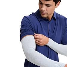 A person's arm inside the sleeve of a shirt