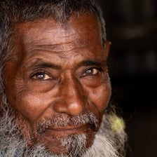 An older person portrayed with a thoughtful, experienced expression.