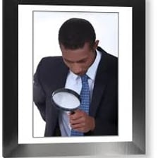 A person closely examining an object with a magnifying glass.