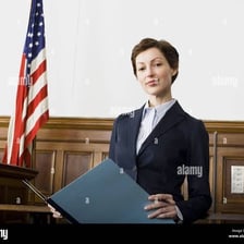 An attorney standing before a courtroom.