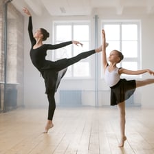 A ballet dancer demonstrating a dance step.