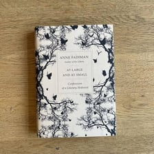 An open book of poetry resting on a desk.