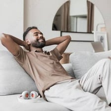 A relaxed person sitting comfortably at home