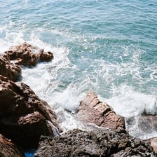 Small waves washing against a rocky shoreline