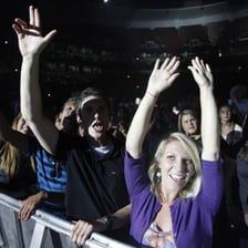 Fans cheering for a performer at a concert.