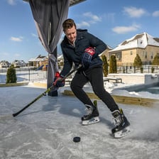 A person skating across an ice rink