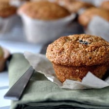 A bran muffin beside wheat bran