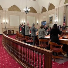 A governing group gathered around a meeting table