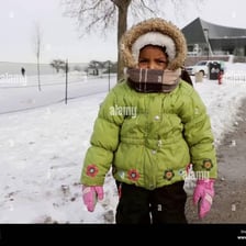 A bundled-up person outdoors in cool weather