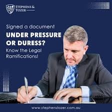 A person signing a document under apparent pressure.