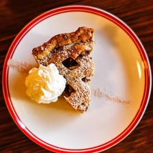 A slice of pie served on a plate at a diner.