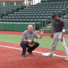 A baseball runner standing on first base.