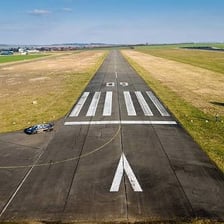 An airport runway with a dark tarmac surface