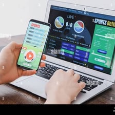 A person placing a wager at a betting counter.