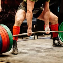 A person performing a single repetition of a strength exercise.