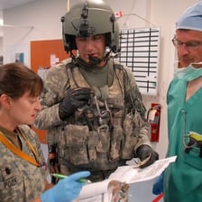 Military medics providing medical care.