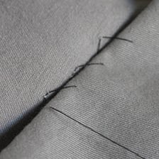 A close view of a sewn dress hem