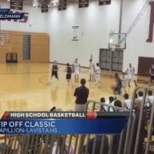 A basketball player scoring a tip-in near the hoop