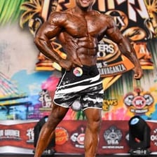 A full-body portrait showing a person’s physique
