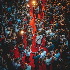 A well-known person receiving attention from photographers
