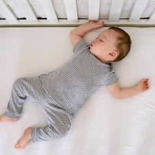 A baby sleeping in a crib.