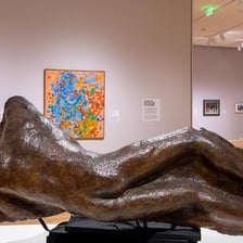 A museum gallery displaying paintings and sculptures