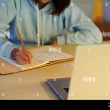 A student writing an essay at a desk.