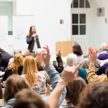 Speaker presenting an argument to an attentive audience.